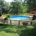 The finished deck and railings for the above ground pool 