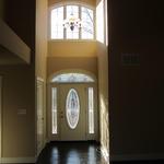 "The Lorraine" main entryway, featuring vaulted ceilings opening into the living room
