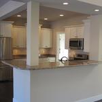 Open concept kitchen with bar area in living room
