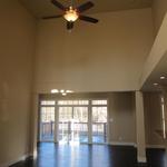 Open concept living room with large sliding doors to deck and wooded backyard
