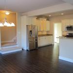 Open concept dining room and kitchen, with staircase leading to bonus room
