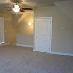Upstairs finished bonus room with doors leading to additional space to finish
