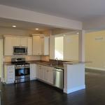 Open concept first floor featuring large kitchen adjacent to dining and living rooms